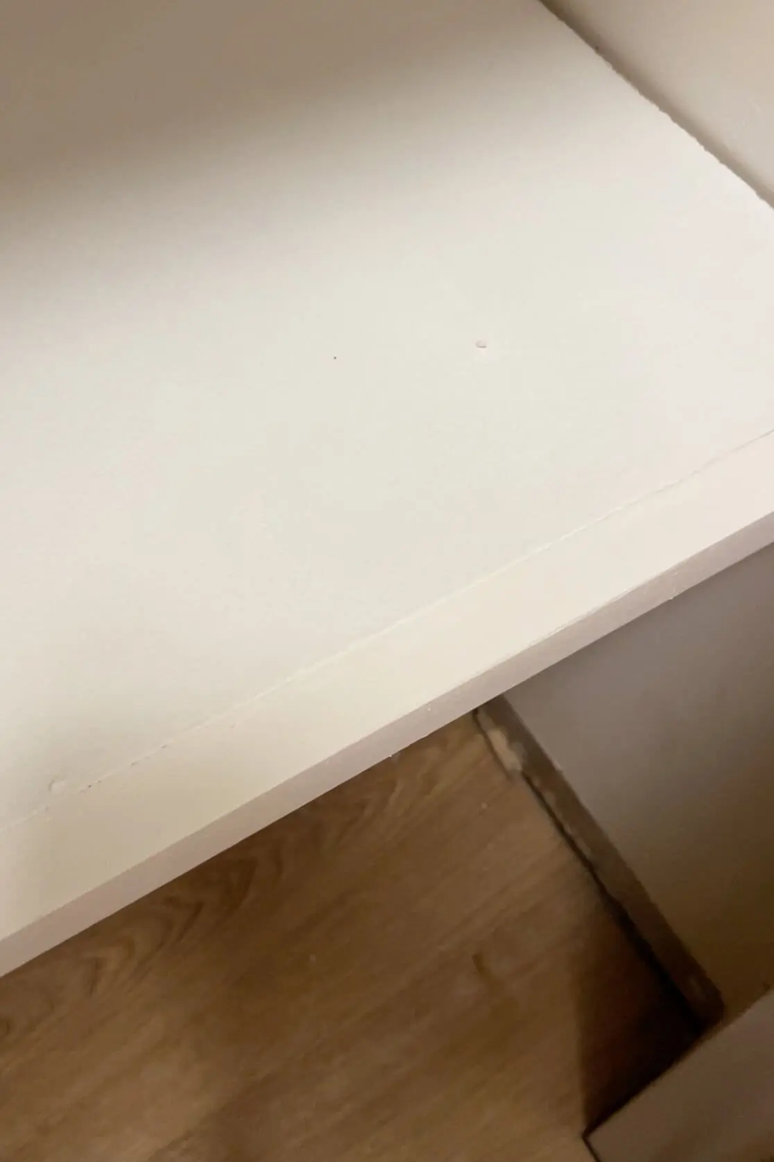 Close-up of a freshly painted surface after using fil-stik to patch a seam on a DIY project.